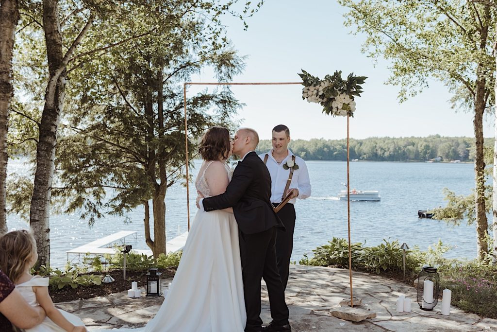 Bride and groom kiss during Wisconsin lakeside elopement ceremony